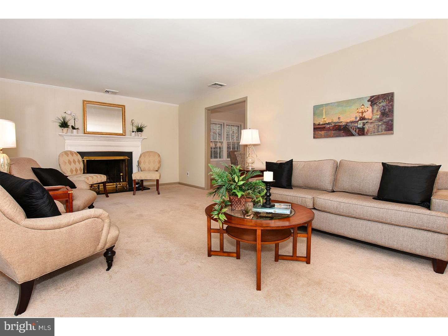 751 Mancill Road Wayne, PA 19087 - Photo 7 of 20 a living room with furniture a fireplace and a flat screen tv