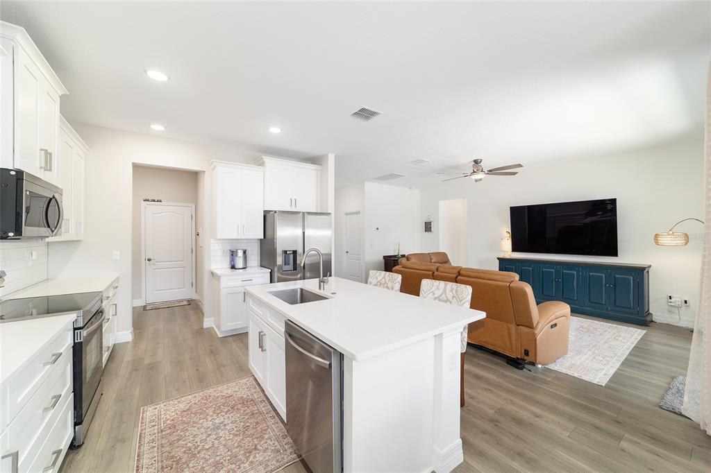 4838 Southwest 130th Street Ocala, FL 34473 - Photo 16 of 48 a large kitchen with stainless steel appliances a large counter top space a sink a refrigerator and a stove