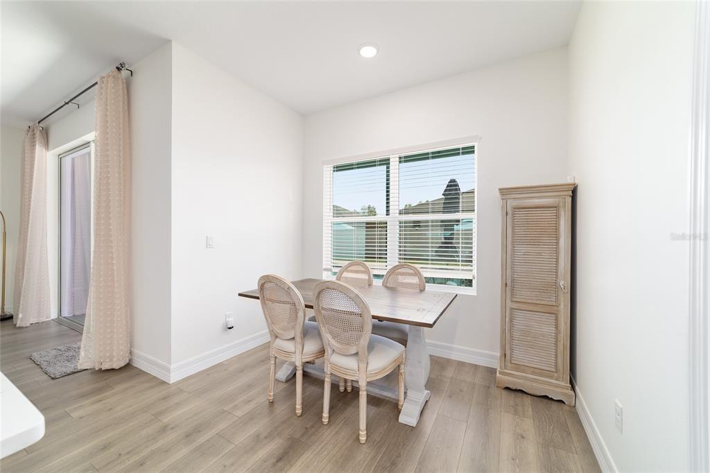 4838 Southwest 130th Street Ocala, FL 34473 - Photo 18 of 48 a view of a dining room with furniture window and wooden floor