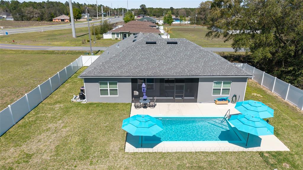 4838 Southwest 130th Street Ocala, FL 34473 - Photo 2 of 48 a front view of a house with swimming pool having outdoor seating