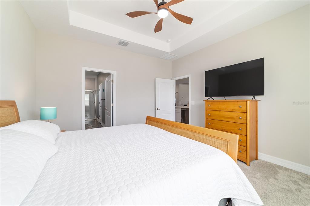 4838 Southwest 130th Street Ocala, FL 34473 - Photo 22 of 48 a bedroom with a bed and a flat screen tv
