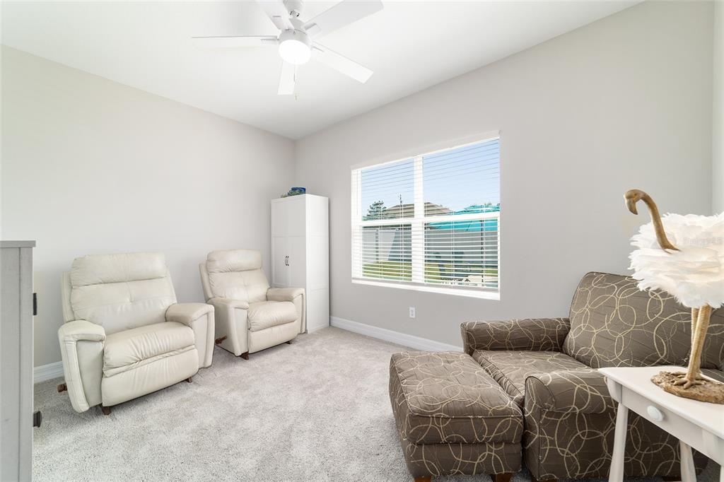4838 Southwest 130th Street Ocala, FL 34473 - Photo 26 of 48 a bedroom with a bed and a couch