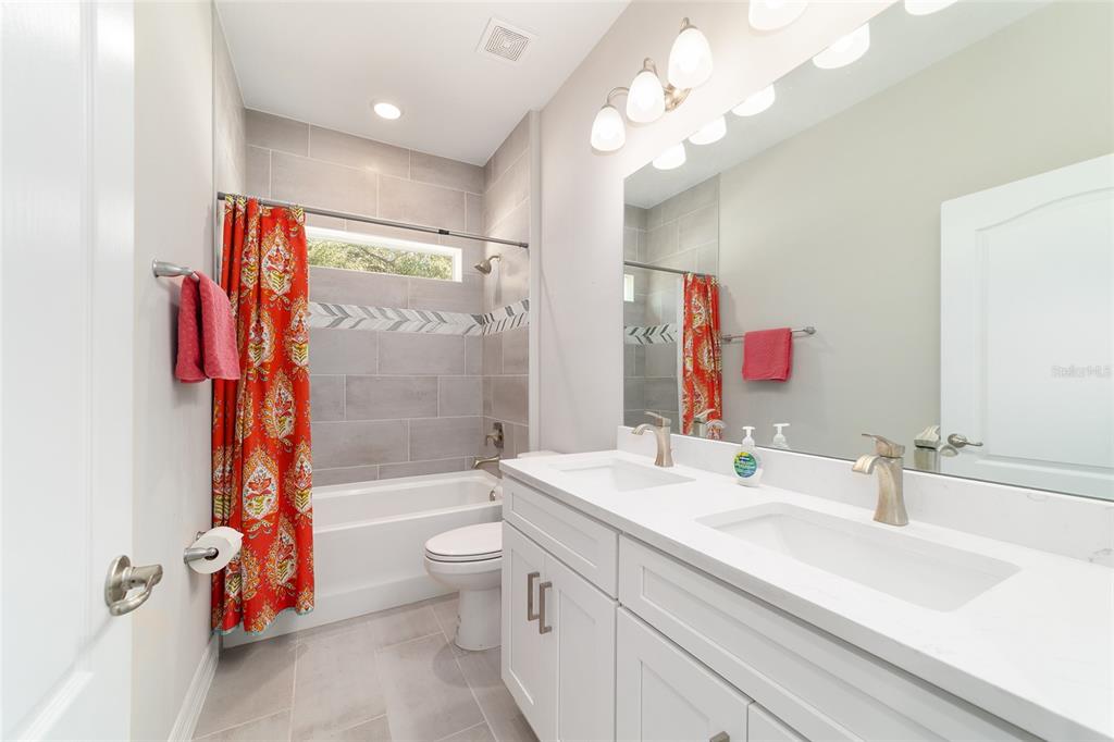 4838 Southwest 130th Street Ocala, FL 34473 - Photo 28 of 48 a bathroom with a sink a toilet and a large mirror