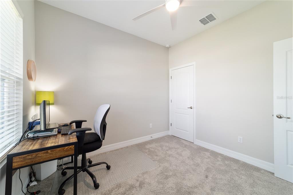 4838 Southwest 130th Street Ocala, FL 34473 - Photo 32 of 48 a view of a workspace with furniture and a window
