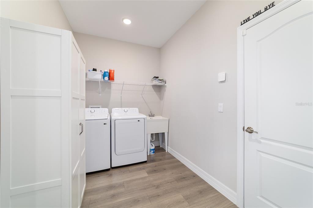 4838 Southwest 130th Street Ocala, FL 34473 - Photo 34 of 48 a utility room with cabinets washer and dryer