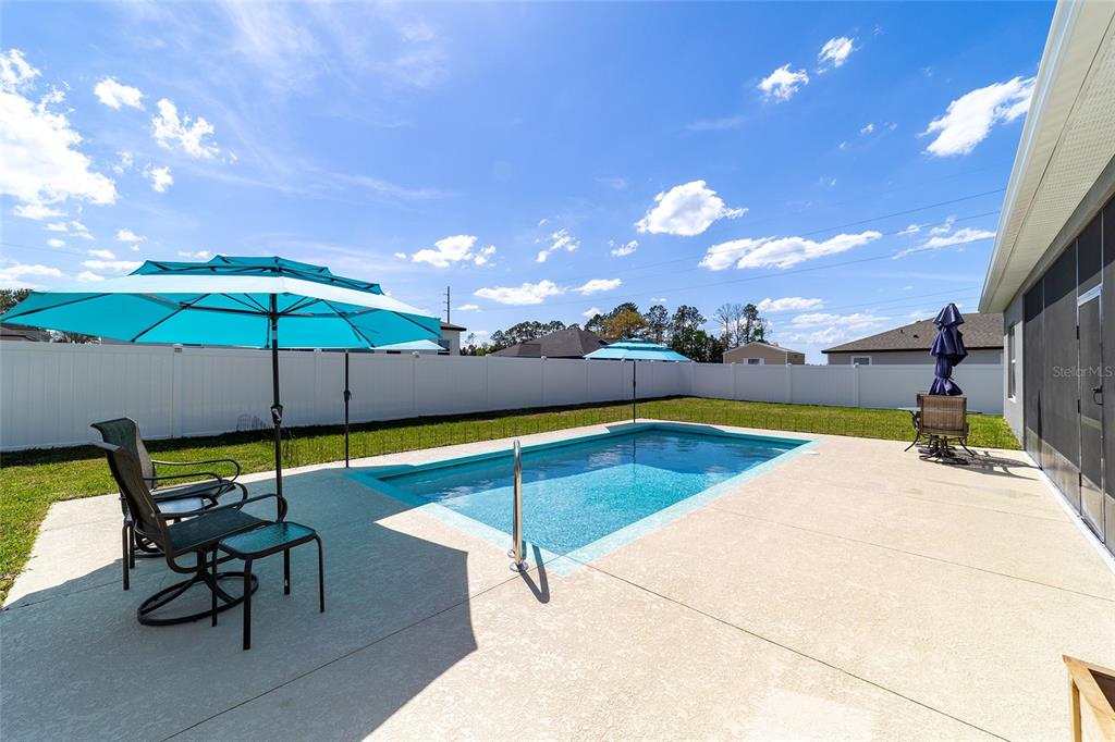 4838 Southwest 130th Street Ocala, FL 34473 - Photo 37 of 48 a view of a swimming pool with lounge chairs