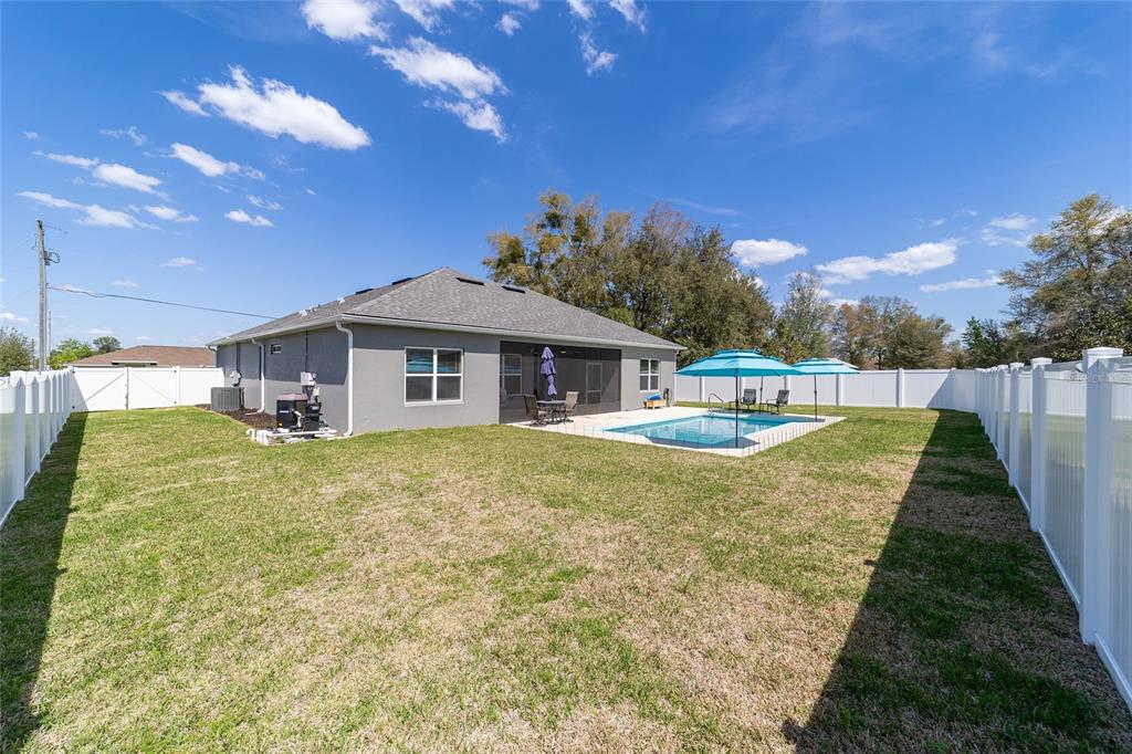 4838 Southwest 130th Street Ocala, FL 34473 - Photo 40 of 48 a view of a house with backyard and a tree