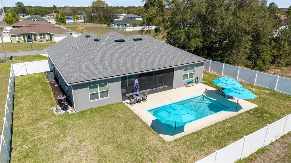 4838 Southwest 130th Street Ocala, FL 34473 - Photo 47 of 48 a view of a house with pool and chairs