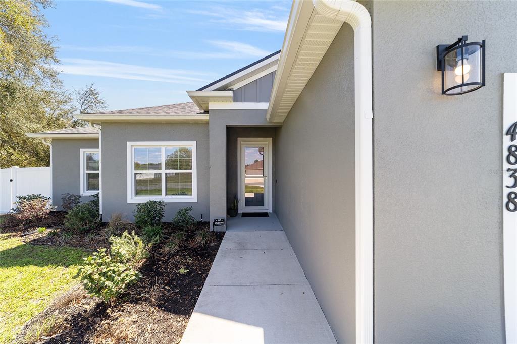 4838 Southwest 130th Street Ocala, FL 34473 - Photo 5 of 48 a front view of a house with garden