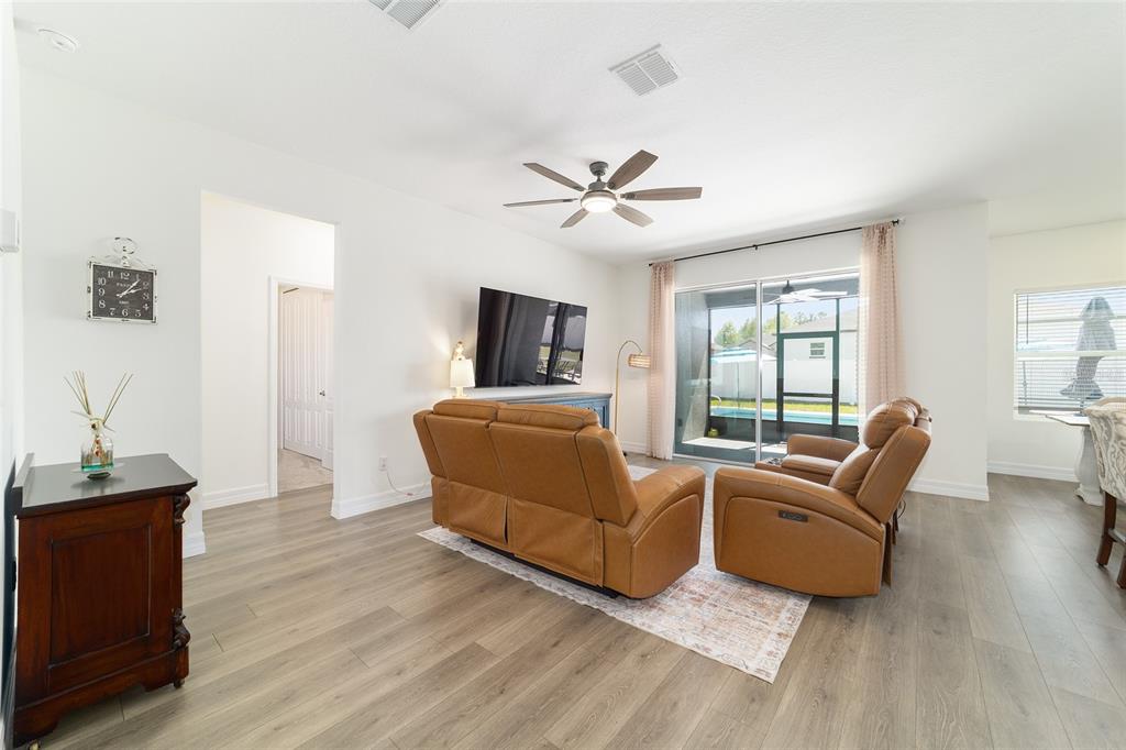 4838 Southwest 130th Street Ocala, FL 34473 - Photo 7 of 48 a living room with furniture and a flat screen tv