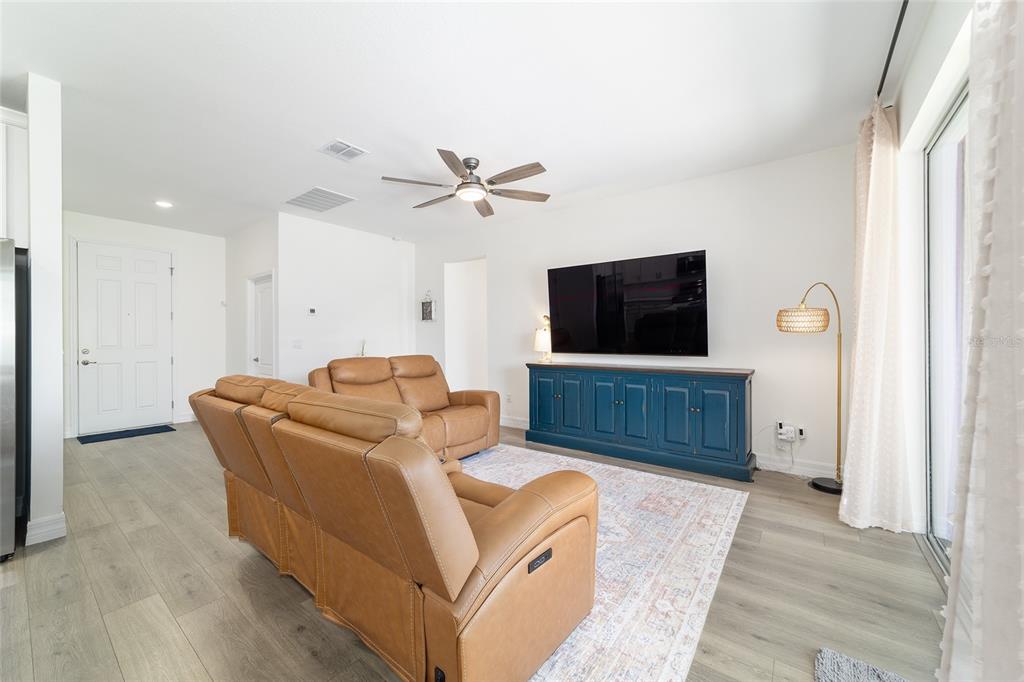 4838 Southwest 130th Street Ocala, FL 34473 - Photo 10 of 48 a living room with furniture and a flat screen tv