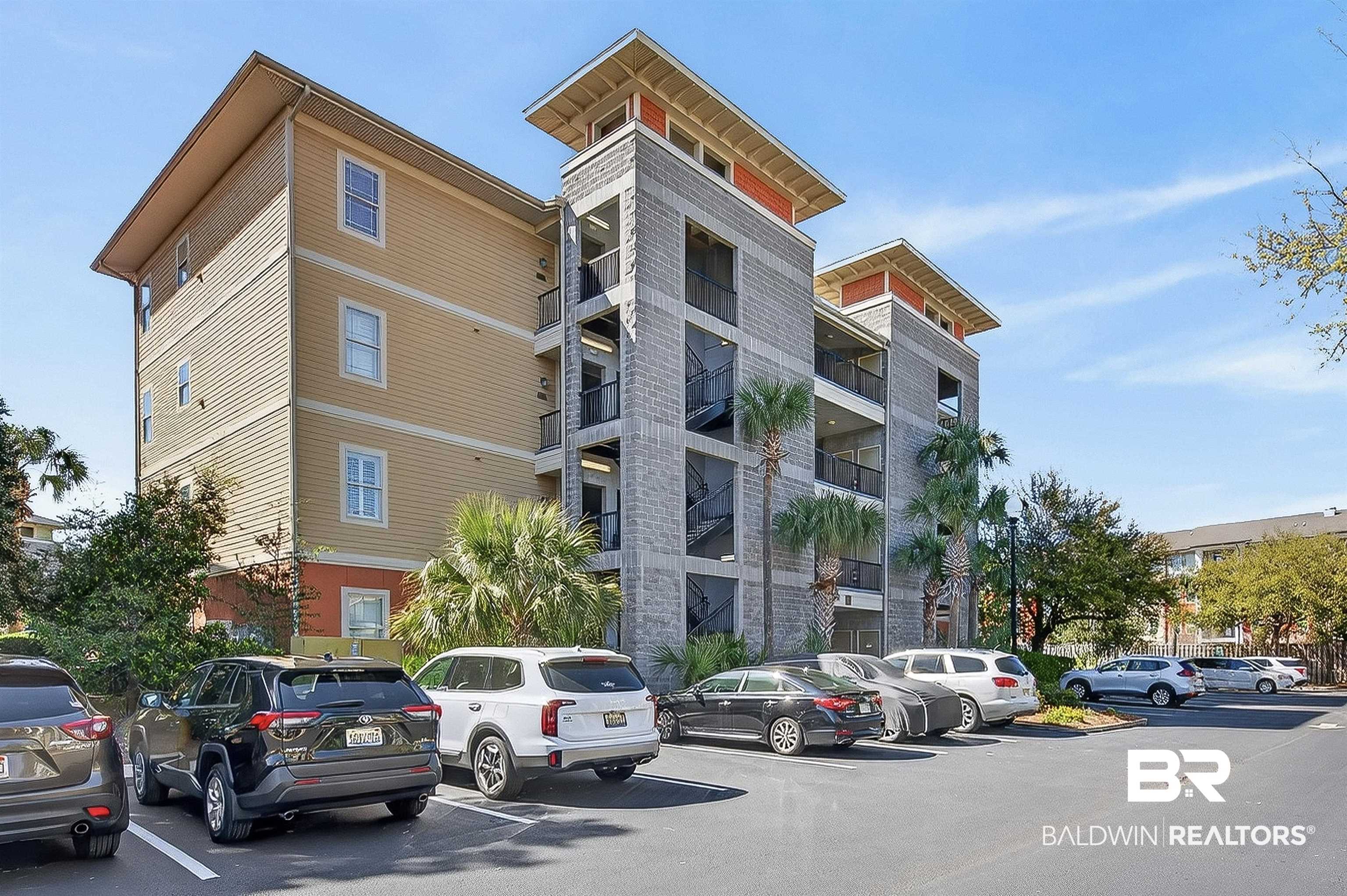 1430 West Regency Road, Unit I102 Gulf Shores, AL 36542 - Photo 29 of 31 View of apartment building / complex with uncovered parking