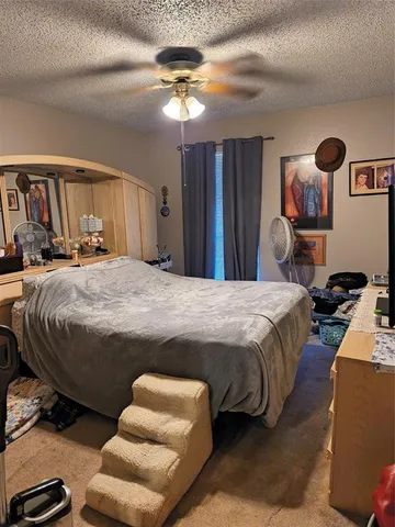 a bedroom with a bed couch and window