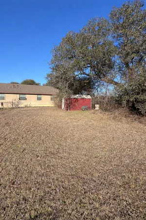 a backyard of a house with a tree
