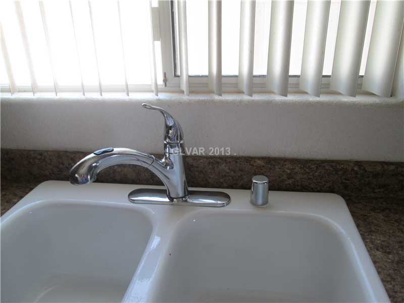 4797 Pinon Pointe Road Las Vegas, NV 89115 - Photo 17 of 25 Kitchen. DOUBLE PORCELAIN SINKS BELOW LARGE WINDOW THAT OVERLOOKS BACK YARD