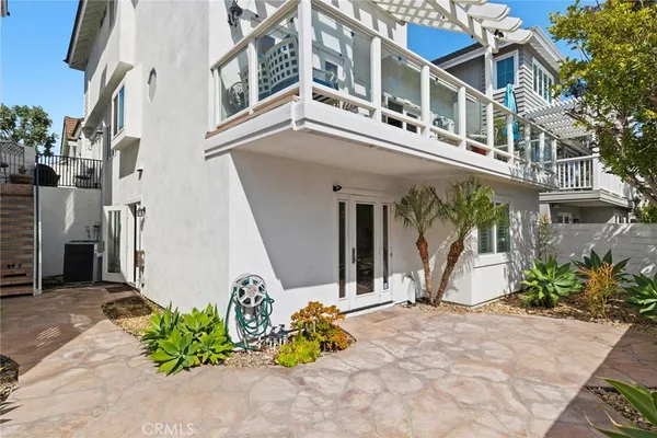 a view of a house with potted plants and more windows