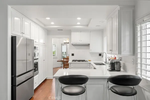 a kitchen with stainless steel appliances a sink a refrigerator and a stove