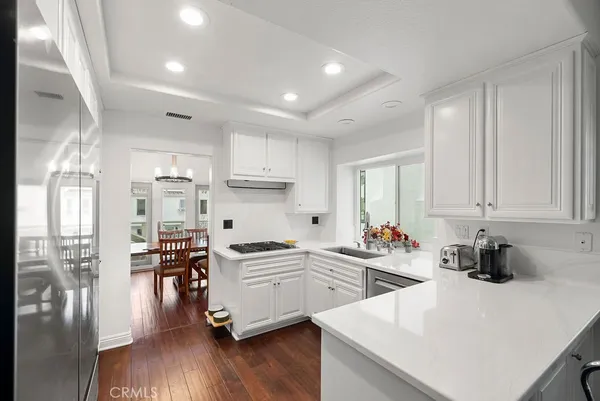 a kitchen with white cabinets and white appliances