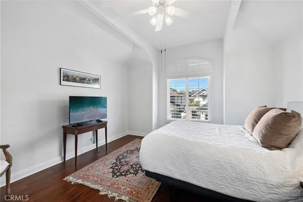 a bedroom with a bed and a television