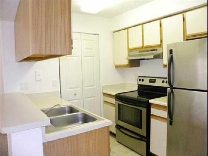 a kitchen with stainless steel appliances a refrigerator sink and cabinets