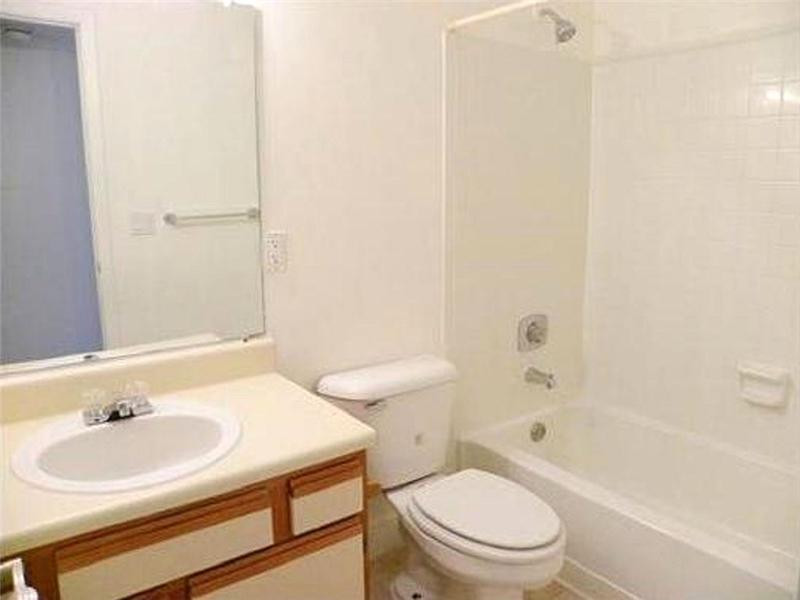 1225 Southwest 46th Avenue, Unit 204 Pompano Beach, FL 33069 - Photo 4 of 5 a bathroom with a sink toilet and shower