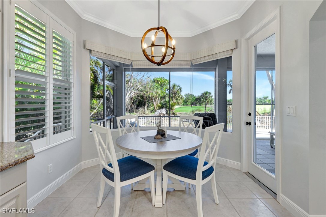 2450 Wulfert Road Sanibel, FL 33957 - Photo 22 of 44 a dining room with furniture window wooden floor and a backyard