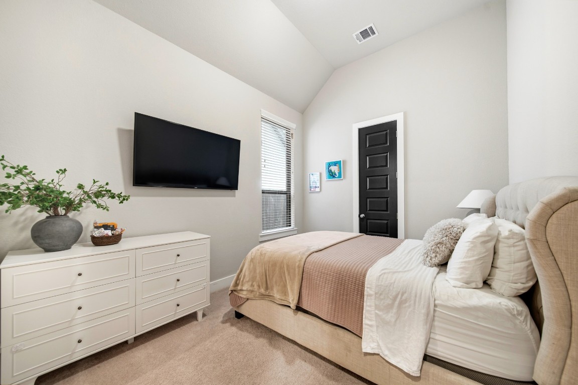 8902 Iron Forge Road Missouri City, TX 77459 - Photo 13 of 38 a bedroom with a bed and a flat screen tv