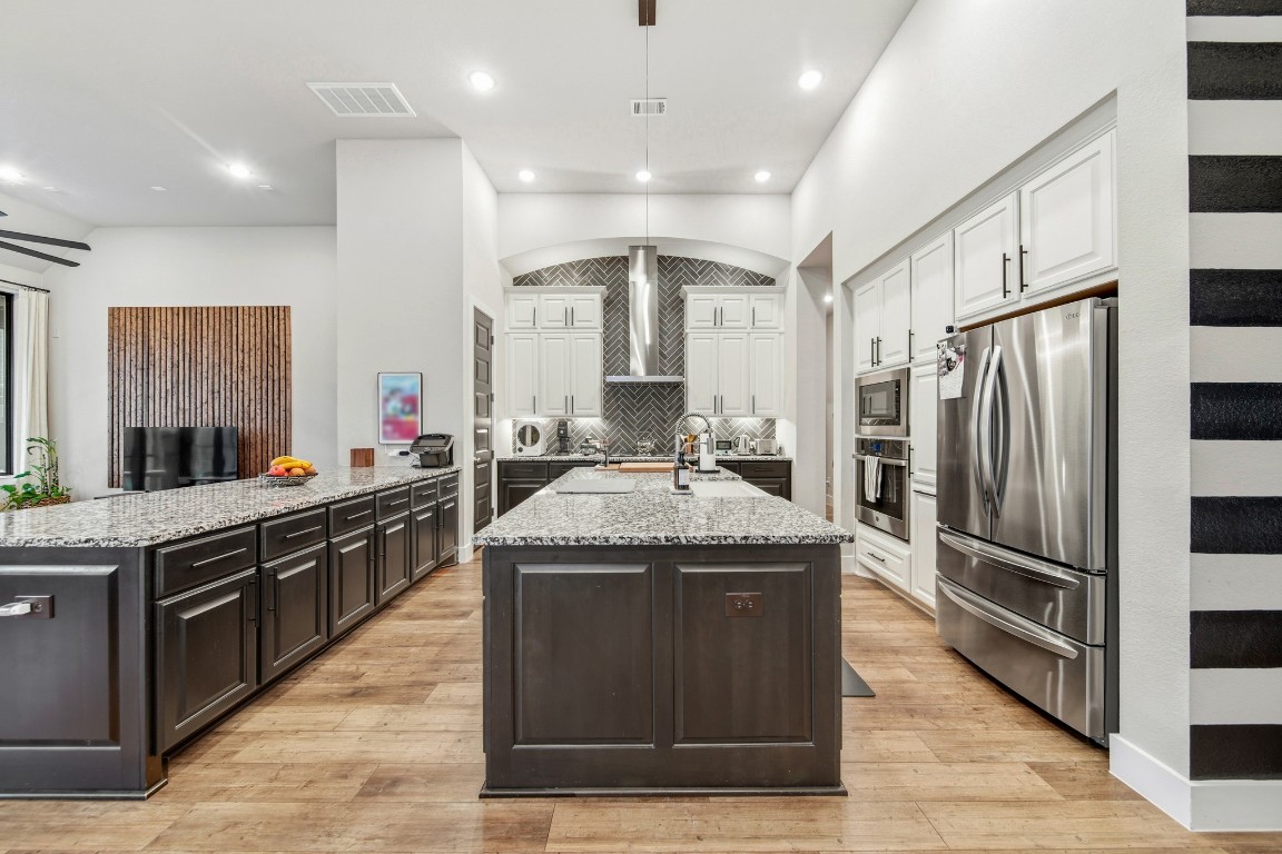 8902 Iron Forge Road Missouri City, TX 77459 - Photo 4 of 38 a kitchen with stainless steel appliances granite countertop a stove and a refrigerator