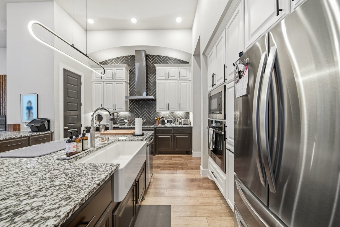 8902 Iron Forge Road Missouri City, TX 77459 - Photo 6 of 38 a large kitchen with stainless steel appliances granite countertop a refrigerator and a sink