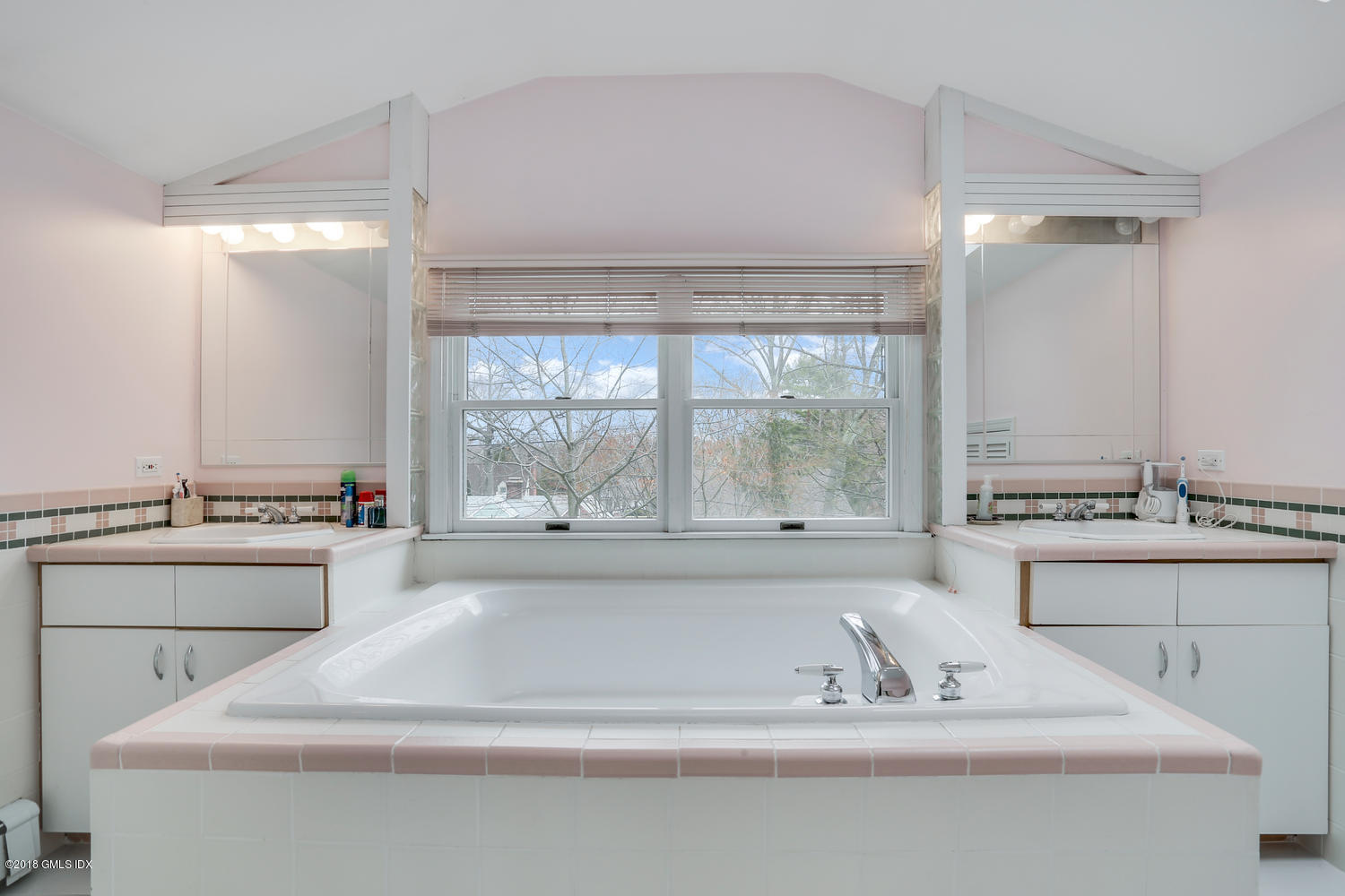 28 Indian Field Road Greenwich, CT 06830 - Photo 17 of 26 a spacious bathroom with a bathtub and next to a window