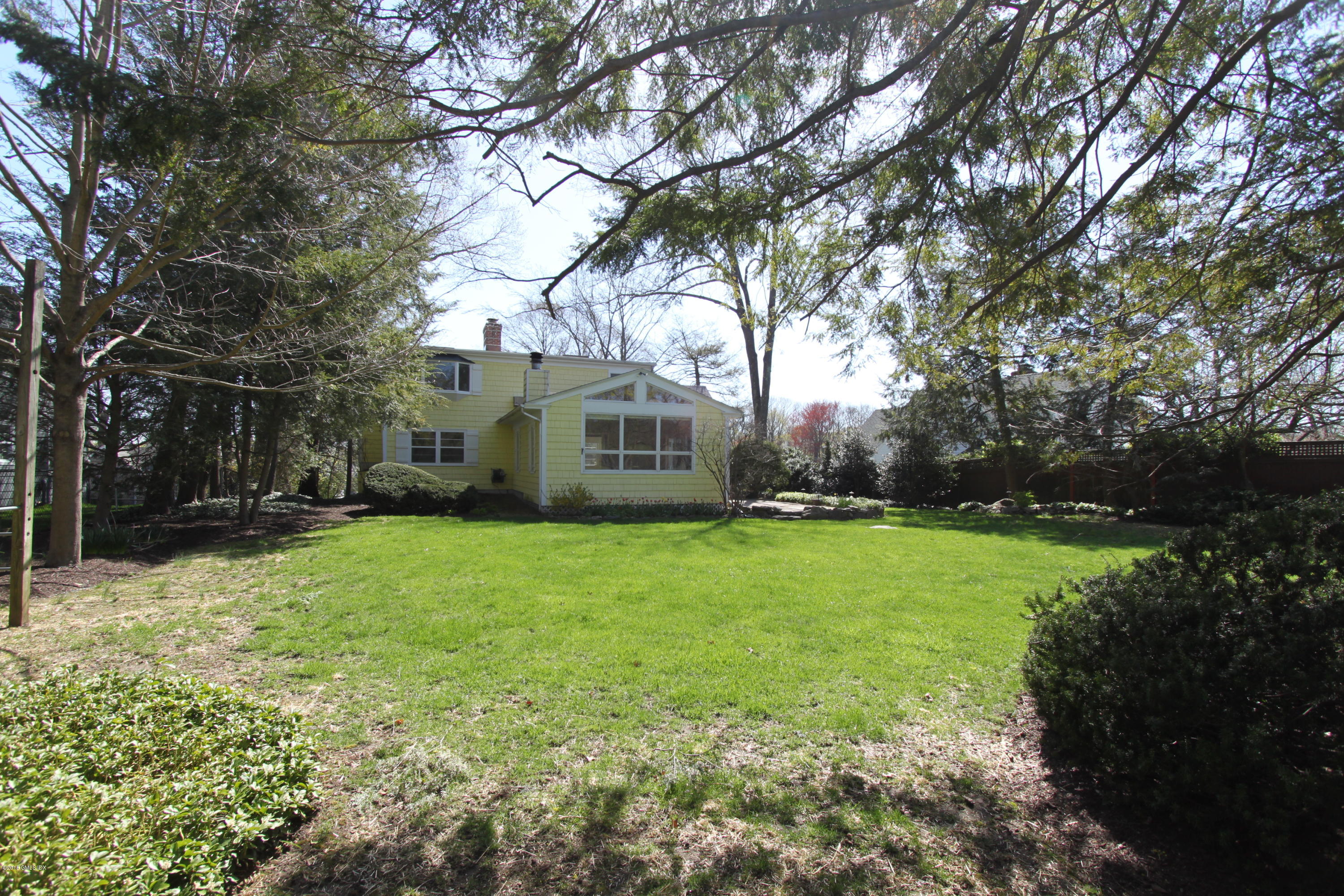 28 Indian Field Road Greenwich, CT 06830 - Photo 20 of 26 a house view with a garden space