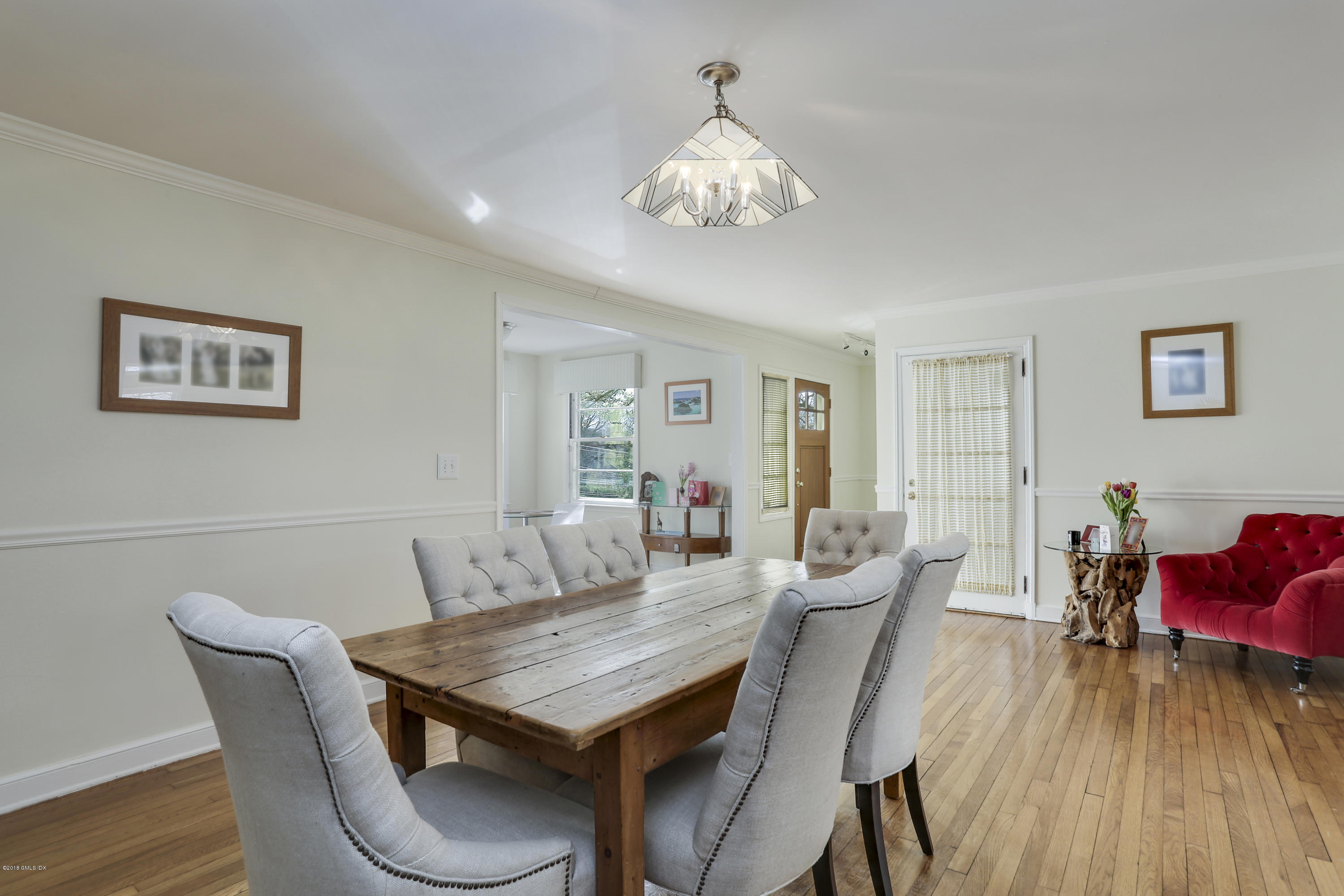 28 Indian Field Road Greenwich, CT 06830 - Photo 6 of 26 a view of a dining room with furniture wooden floor and chandelier