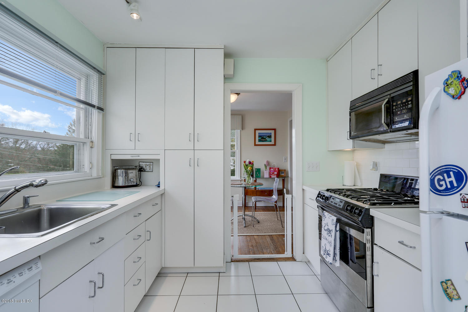 28 Indian Field Road Greenwich, CT 06830 - Photo 8 of 26 a kitchen with granite countertop a sink a stove and cabinets