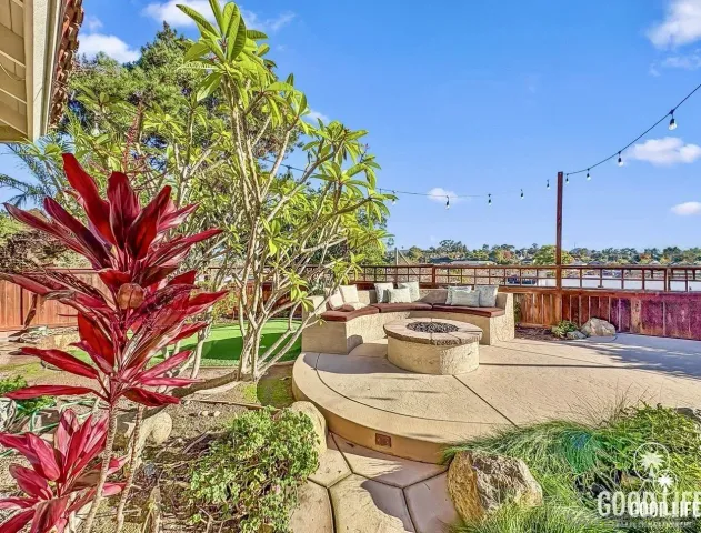 a view of a terrace with furniture and a garden