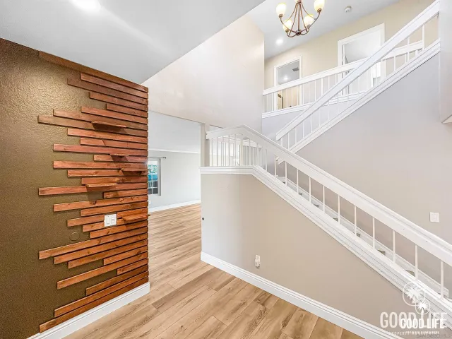 a view of entryway and hall with wooden floor