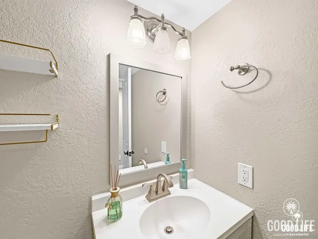 a bathroom with a sink and a mirror