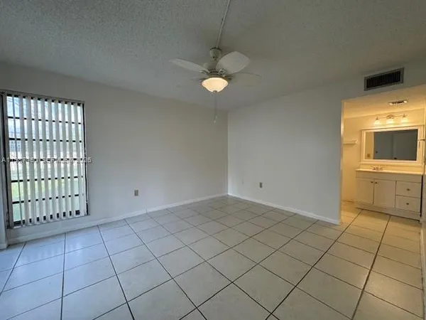 a view of a kitchen with an empty space and a sink
