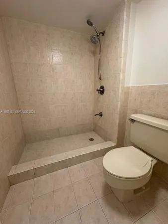 a bathroom with a toilet and shower