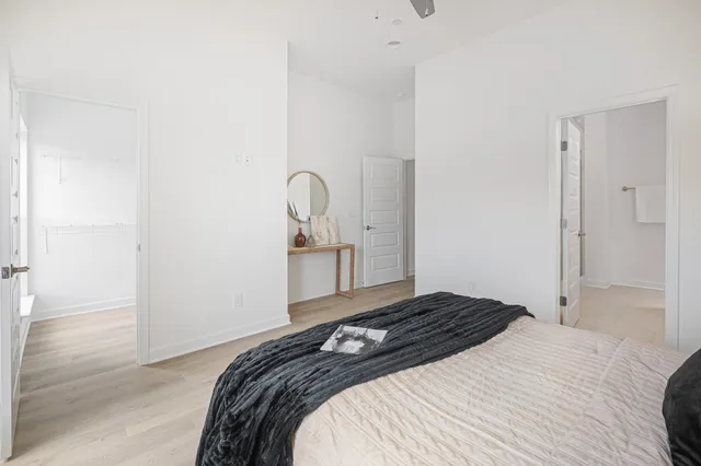 a bedroom with a bed and wooden floor