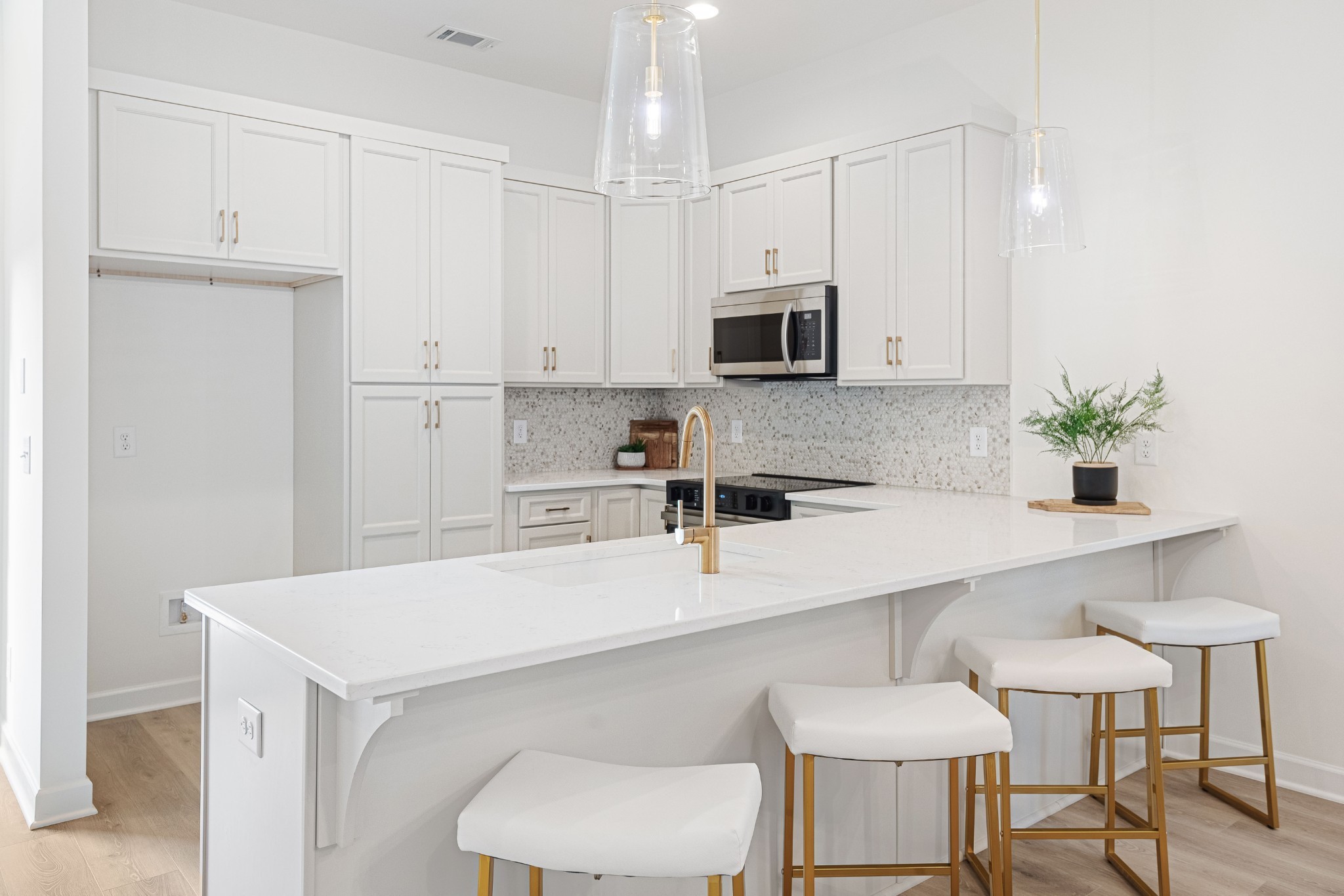 201 B Folsom Pass Spring Hill Spring Hill, TN 37174 - Photo 21 of 27 a kitchen with stainless steel appliances a white table chairs in it and white cabinets