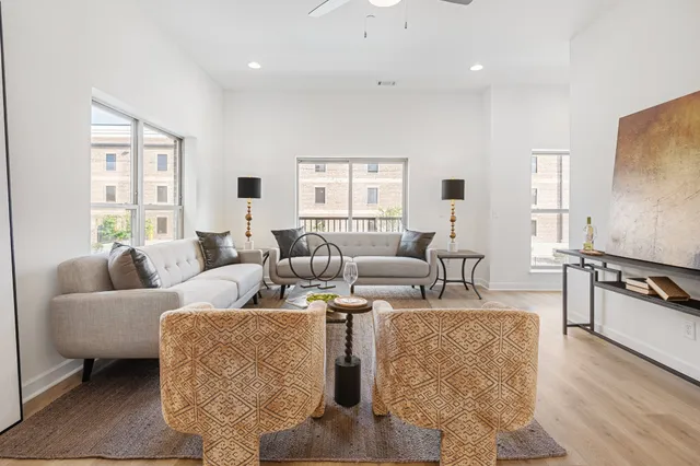 a living room with fireplace furniture and wooden floor