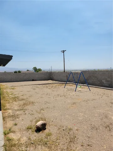 a view of a livingroom with wooden floor and a window