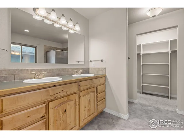a bathroom with a sink a vanity and a large mirror