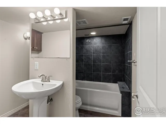 a bathroom with a sink a mirror and a bathtub