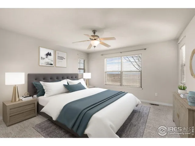 a bedroom with a large bed and a window