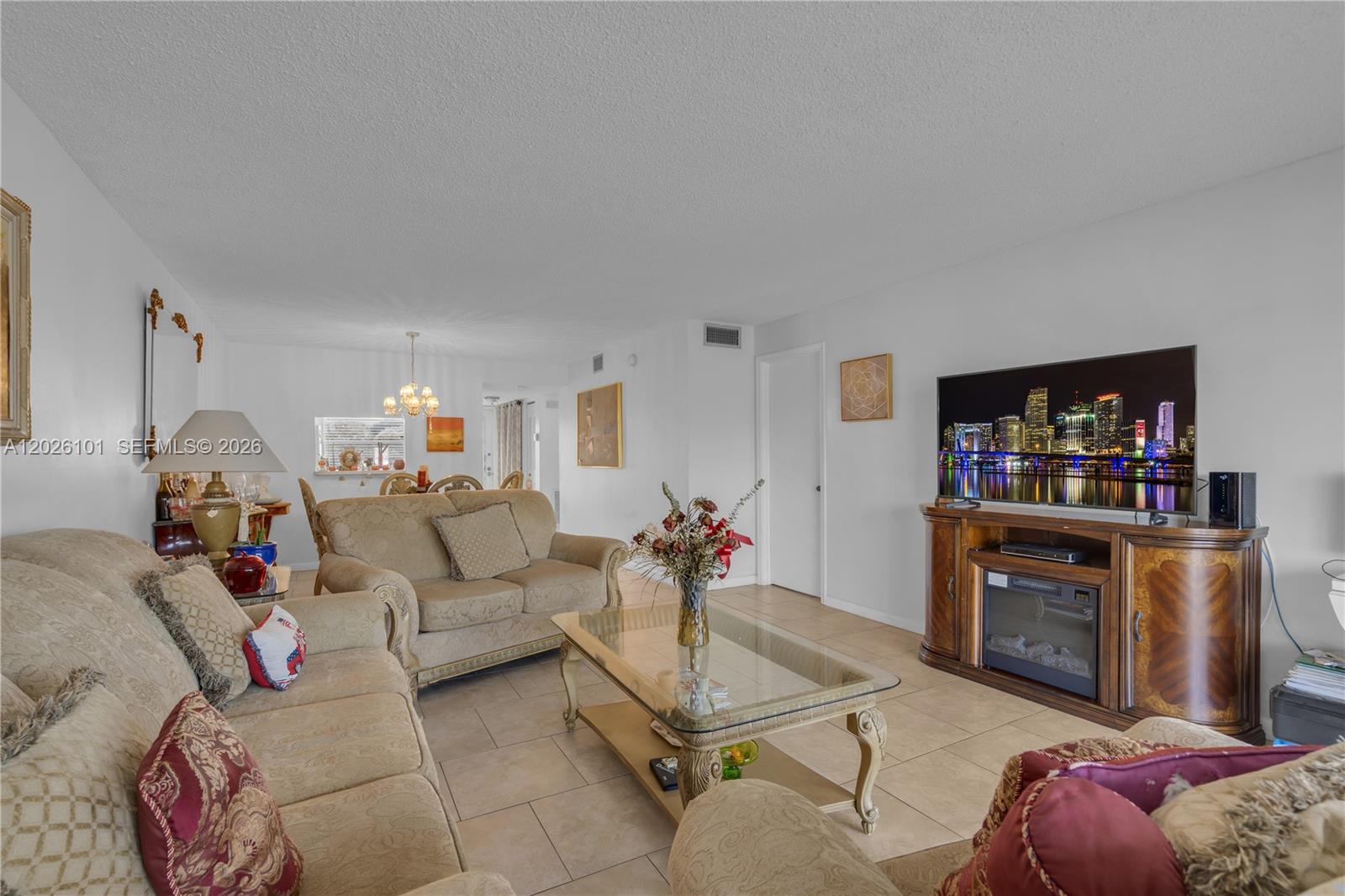 3551 Inverrary Drive, Unit 208 Lauderhill, FL 33319 - Photo 7 of 34 a living room with furniture a flat screen tv and a fireplace