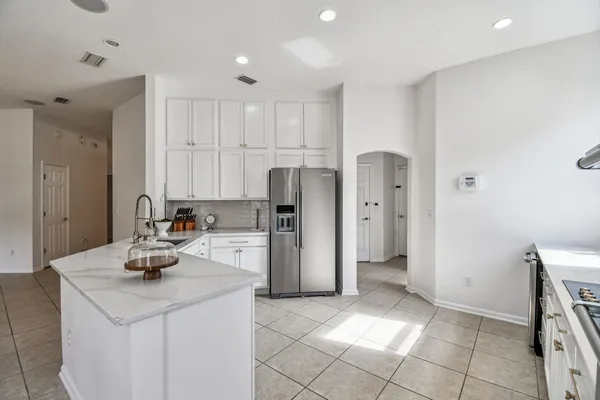a kitchen with stainless steel appliances a stove sink and microwave
