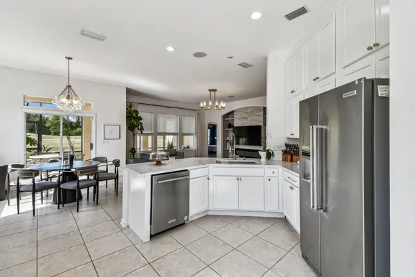 a dining room with furniture a chandelier and window