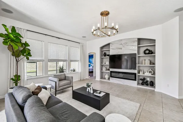 a living room with furniture a flat screen tv and a fireplace