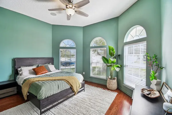 a bedroom with a bed and glass door